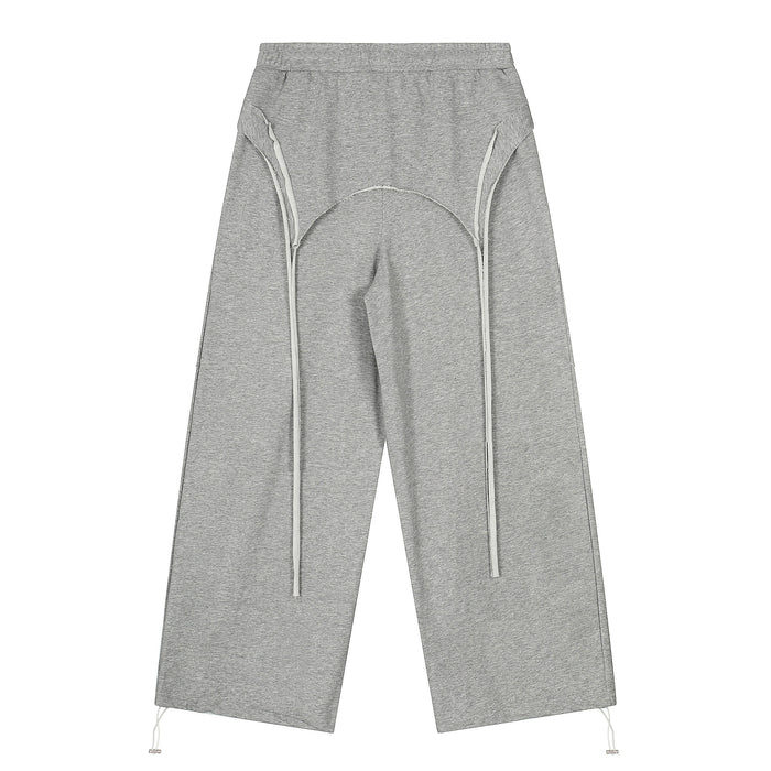 Gray wide-leg sweatpants with curved seam details and long drawstrings, front view