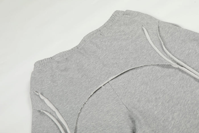 Close-up of gray sweatpants upper back with curved seam and drawstring detail