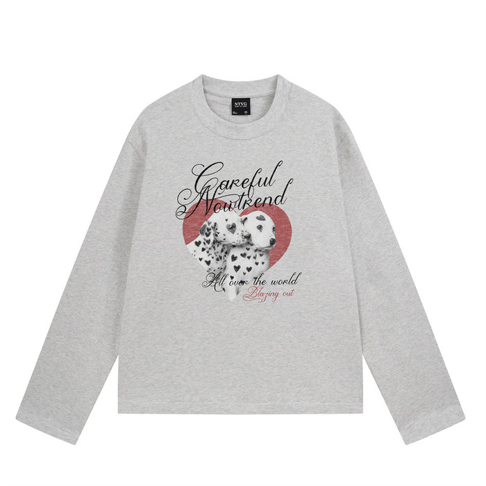 Light gray long sleeve shirt shown from the front with spotted puppies, red heart, and script graphic