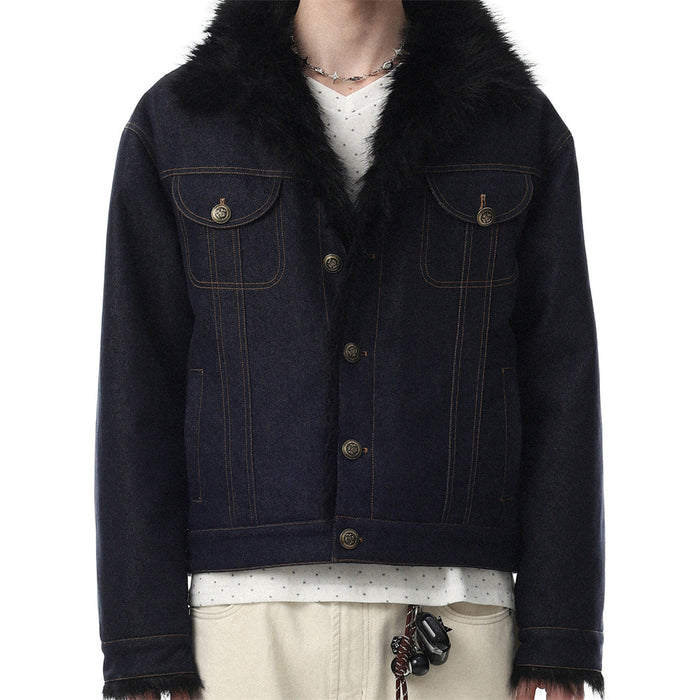 Dark indigo denim jacket worn from the front with black faux fur collar, chest pockets, and gold-tone buttons