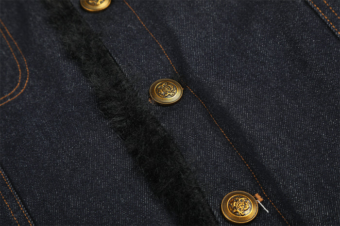 Close-up of the denim front placket showing black faux fur trim and ornate gold-tone buttons