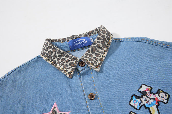 Close-up of the denim shirt's leopard-print collar, front buttons, and colorful embroidered patches
