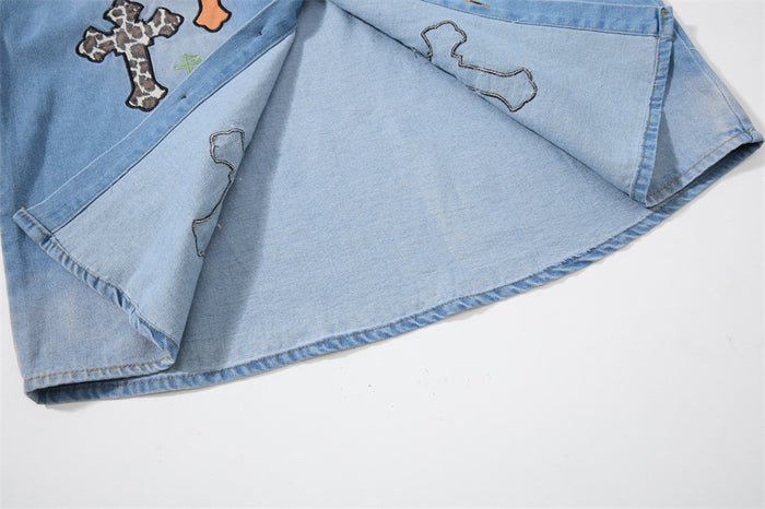 Inside view of the denim shirt's folded lower hem showing interior stitching and patch outlines