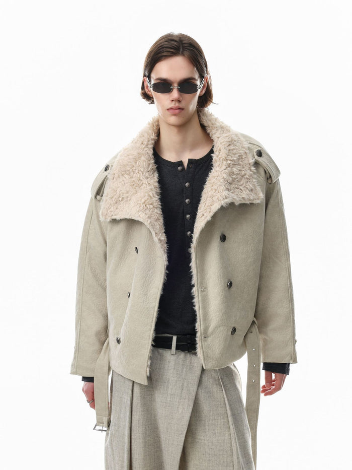 Model wearing a cream jacket open to reveal its plush shearling collar and double-breasted front