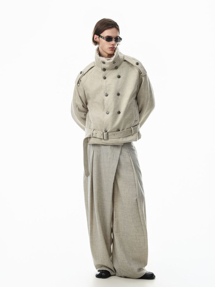 Rear three-quarter view of a cream belted jacket on a model, showing the back and shoulder details