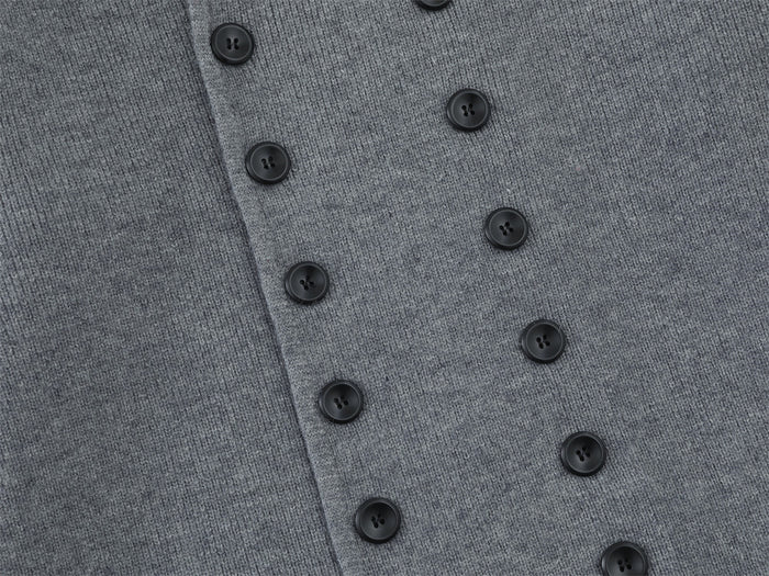 Close-up of the gray cardigan's double-breasted front showing two vertical rows of dark buttons