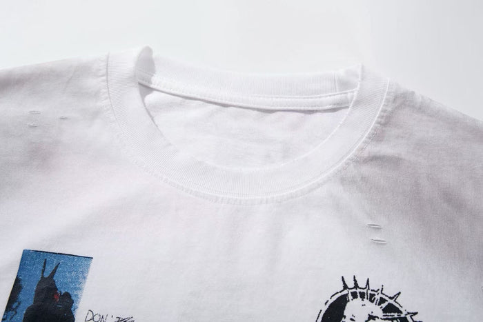 White oversized T-shirt with distressed collar and collage-style graphic print on the chest