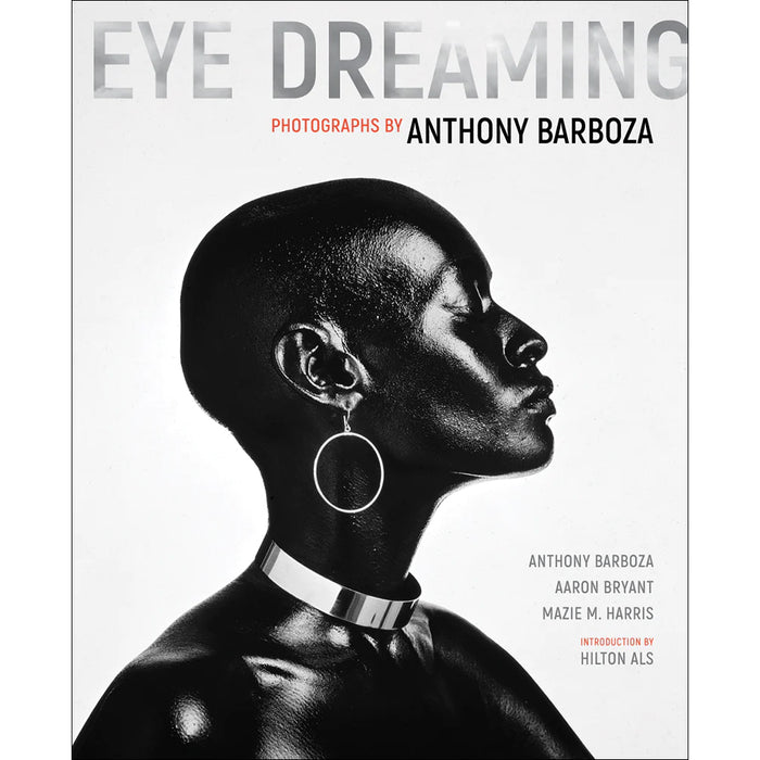This image features the cover of "Eye Dreaming: Photographs by Anthony Barboza," a monograph that explores the career of the celebrated photographer Anthony Barboza. The cover showcases a striking black and white photograph of a woman in profile, accentuated with large, circular earrings and a choker necklace, highlighting Barboza’s ability to capture intense, intimate portraits.