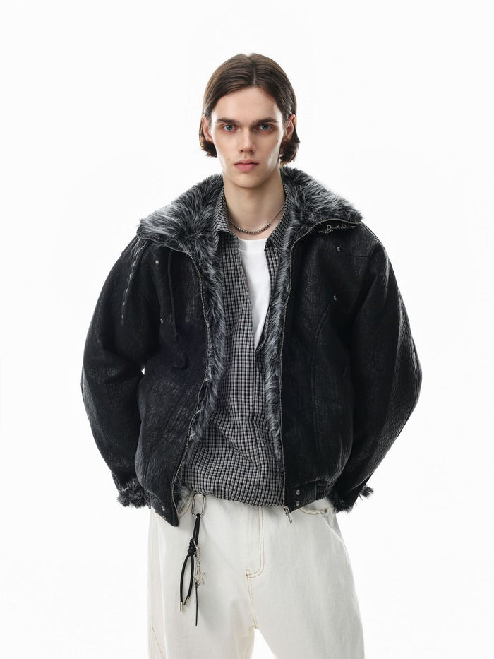 Model wearing a black padded bomber jacket with gray faux fur collar and front zipper