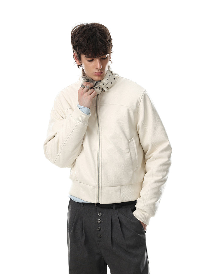 Model wearing the white faux leather bomber jacket, adjusting its fur-trimmed buckled collar