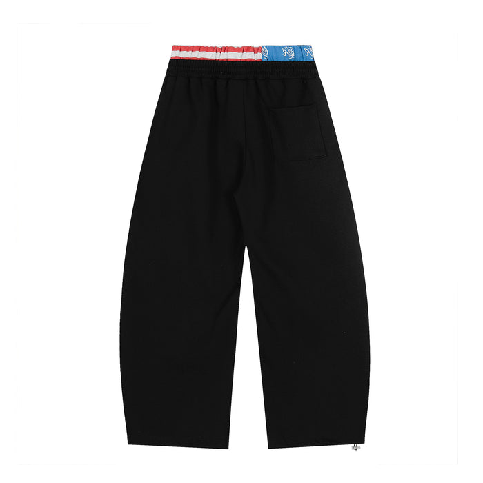 Back view of black wide-leg sweatpants with one back pocket and flag waistband detail