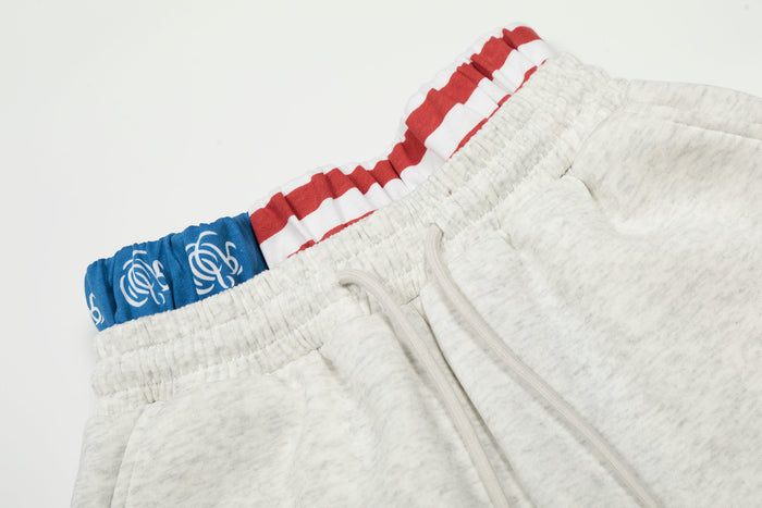 Close-up of heather gray sweatpants waistband with red, white, and blue flag print