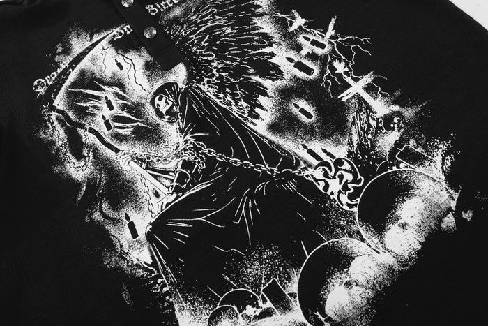 Close-up of black grim reaper graphic on Henley shirt front with skulls and chains