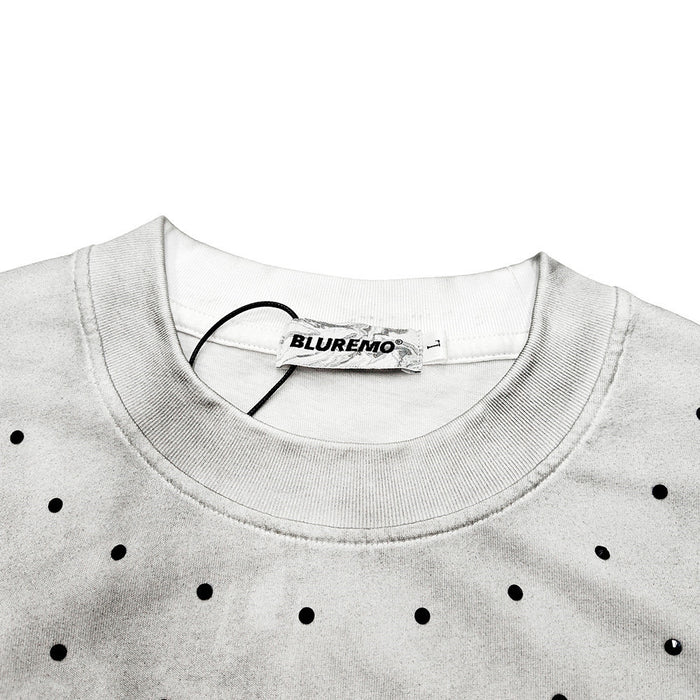 Light gray distressed oversized T-shirt with black dotted Gothic logo print and ribbed crew neck, close-up neckline detail