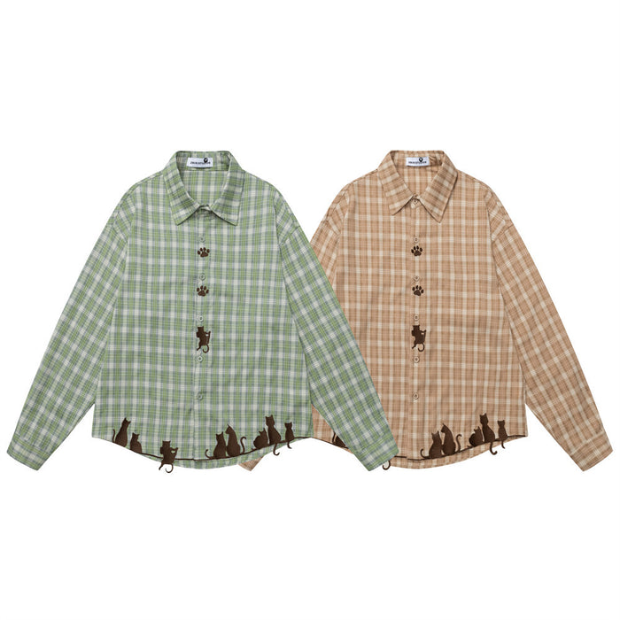 Green and tan plaid long-sleeve button-up shirts with cat embroidery along the hems