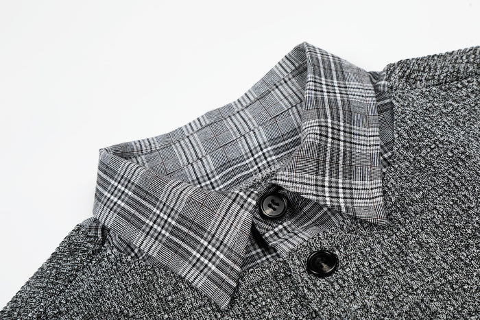 Close-up of a layered gray knit check shirt with plaid collar and black buttons on a white background