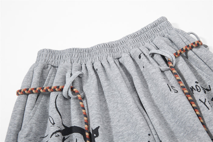 Close-up of grey shorts waistband with braided rope drawstring