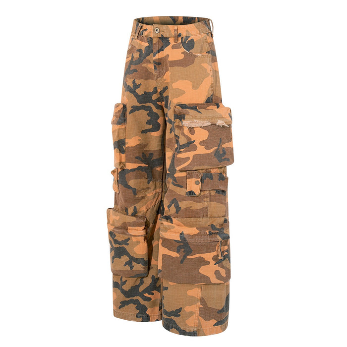 Angled side view of wide-leg camo cargo pants with multiple flap pockets