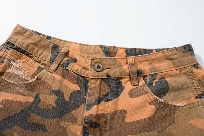 Close-up of camo pants waistband with button closure and belt loops