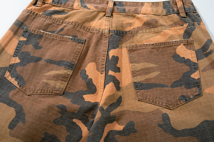 Close-up of back pockets on camo cargo pants with stitched patch details