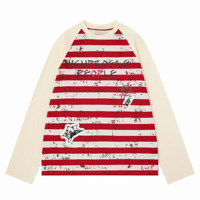 Cream raglan long sleeve tee with red stripes, graffiti print, and graphic patches on front