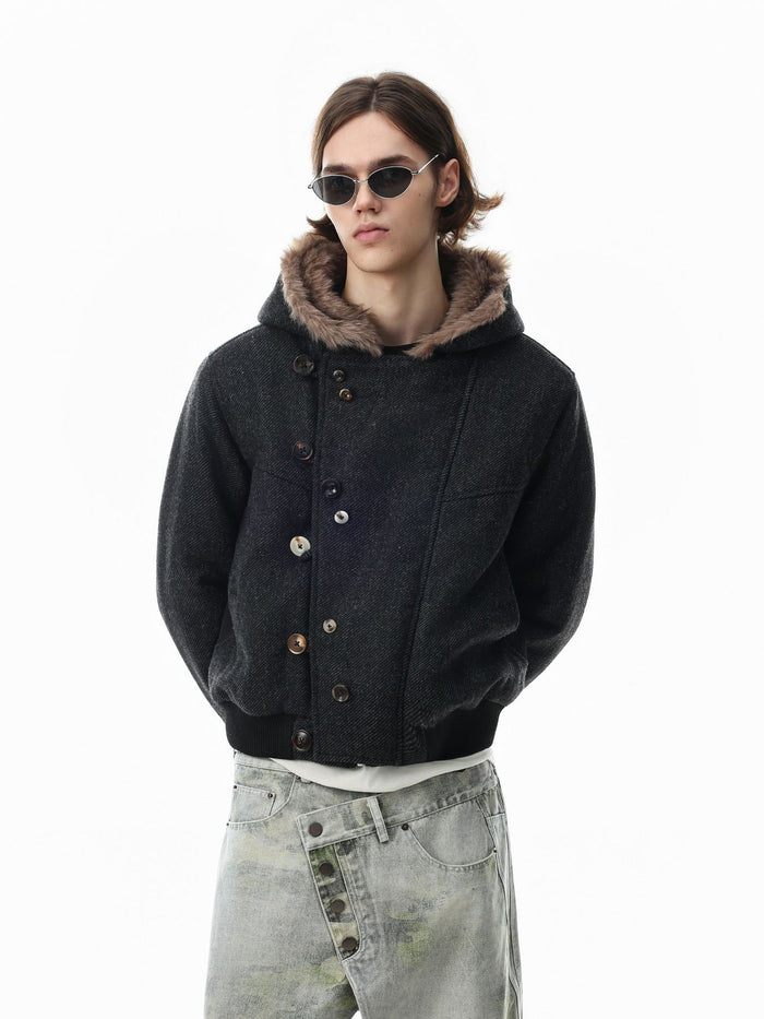 Black hooded bomber jacket shown on a model with faux fur trim and offset button closure