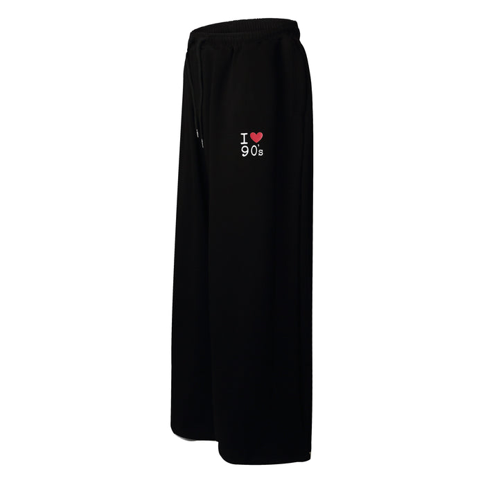 Black sweatpants side view with I heart 90s embroidery on the hip