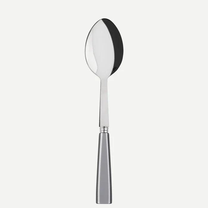 The Sabre Icone Light Grey Serving Spoon features a reflective, oval-shaped stainless steel bowl and a solid metallic handle, shown against a plain white background.