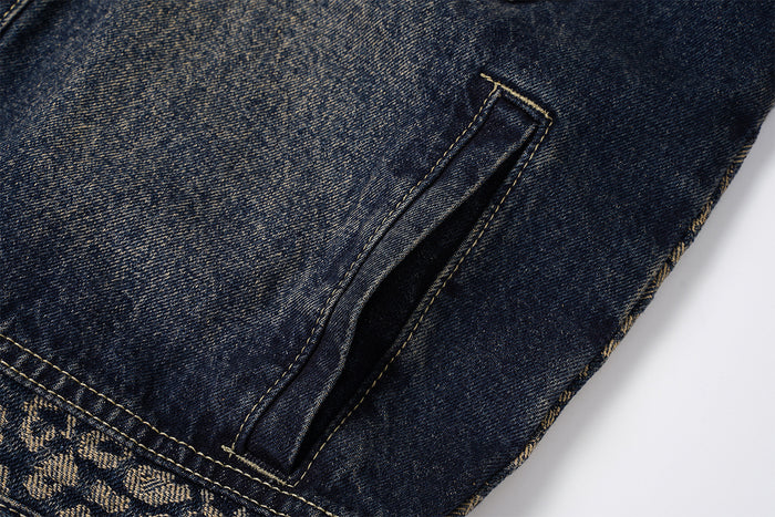 Close-up of a vertical welt hand pocket opening on the dark washed denim jacket body