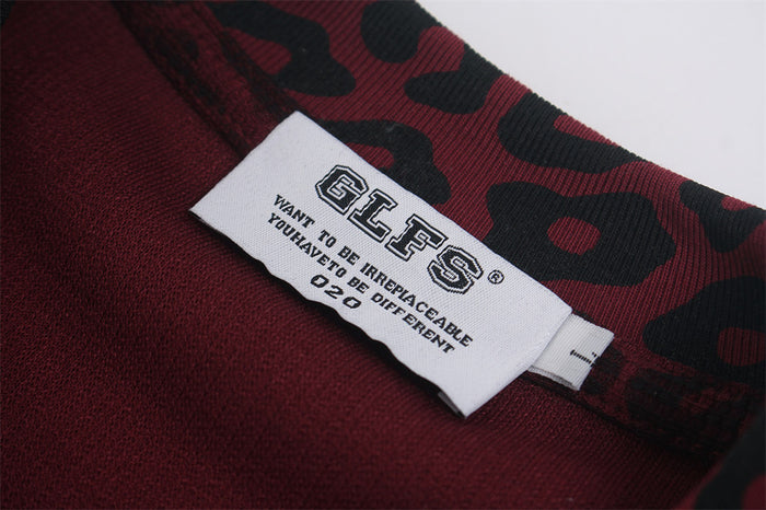 Close-up of the sewn neck label inside the burgundy and black leopard-print shirt