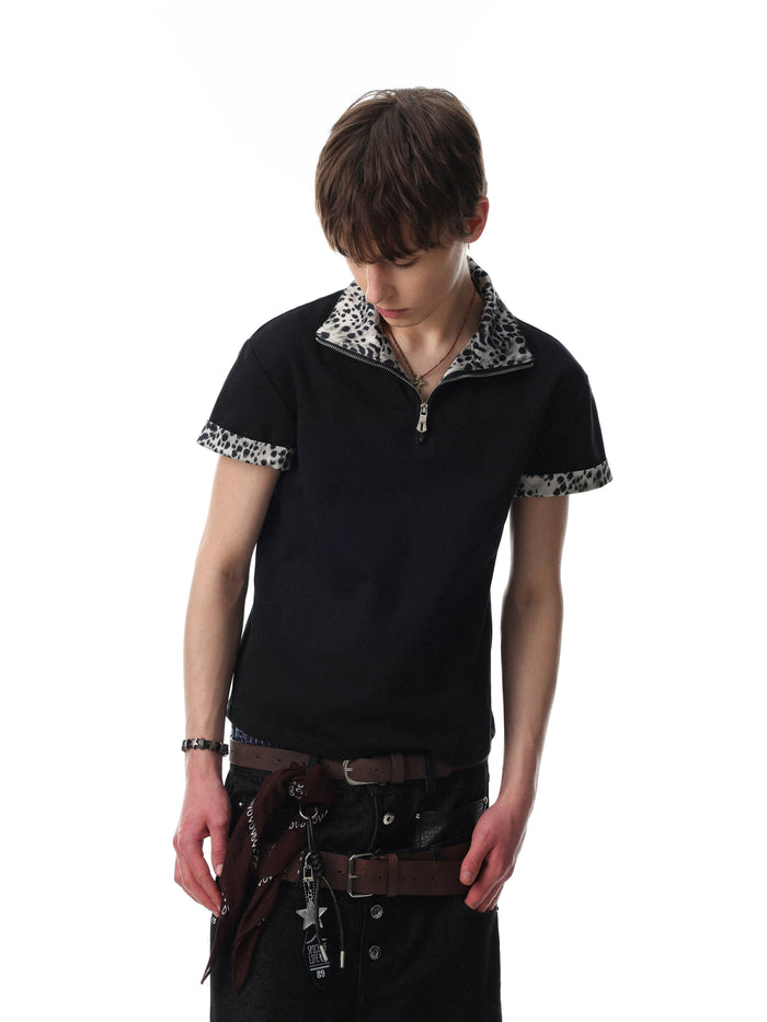 Black quarter-zip polo shirt with leopard print trim on collar and sleeves, styled on a model against a white background