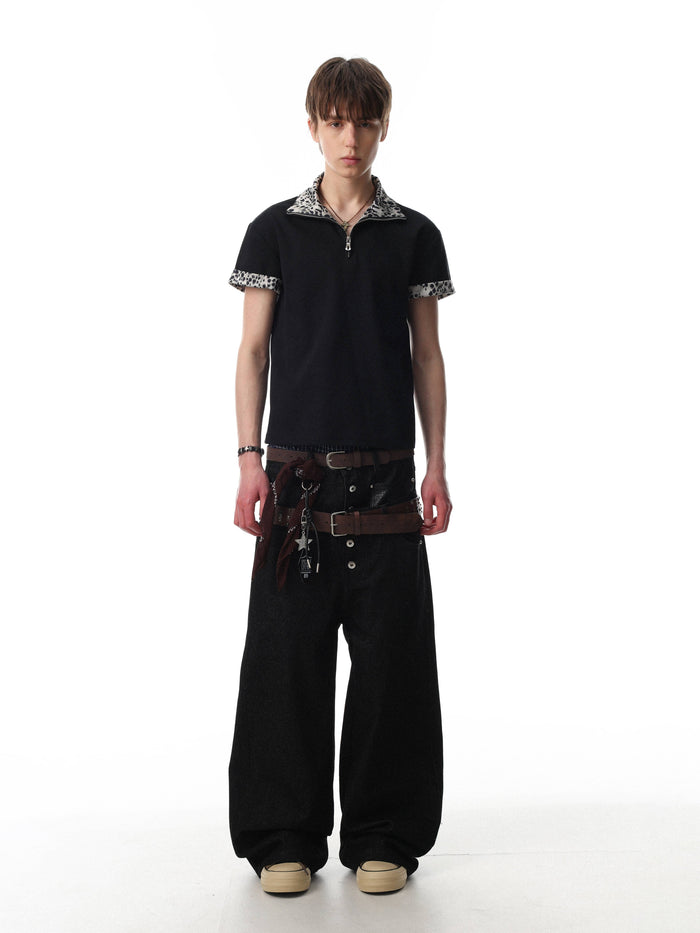 Black quarter-zip polo shirt with leopard-print collar and sleeve trim, styled on a model with streetwear pants