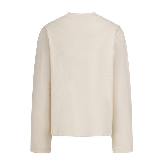 Cream long sleeve crewneck shirt shown from the back with plain fabric and stitched cuffs