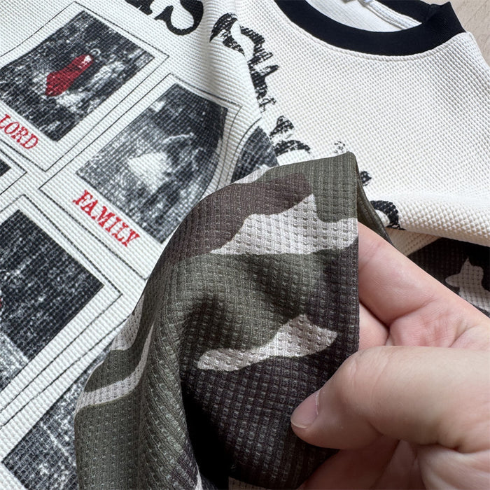 Close-up of the shirt’s textured camouflage sleeve beside the cream graphic waffle-knit body