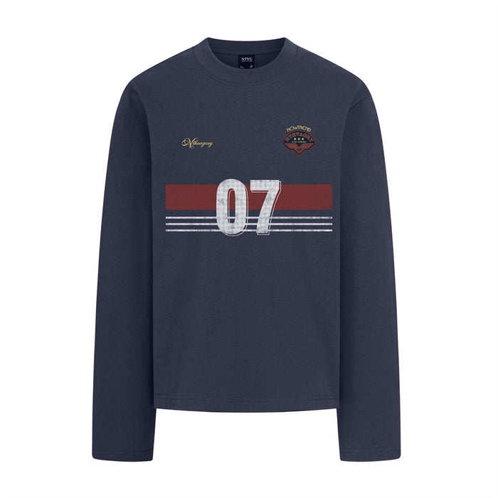 Front view of a navy long sleeve crewneck tee with a red stripe, white 07 graphic, crest, and script detail