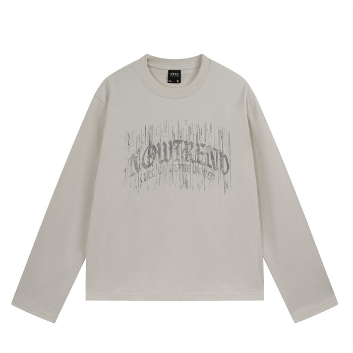 Off-white long sleeve tee shown front-facing with a distressed gray gothic letter graphic