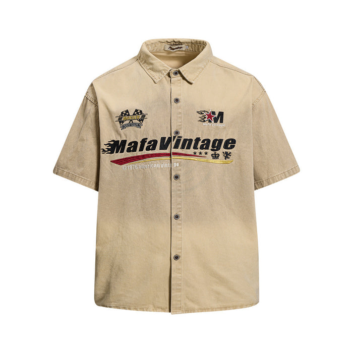 Washed khaki short sleeve button-up shirt with racing-style embroidery on the front