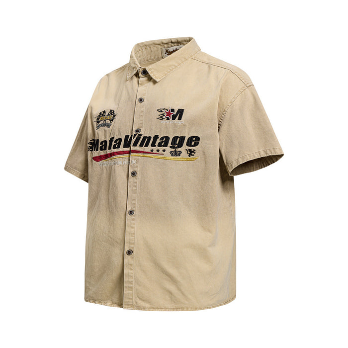 Three-quarter front view of washed khaki embroidered short sleeve button-up shirt