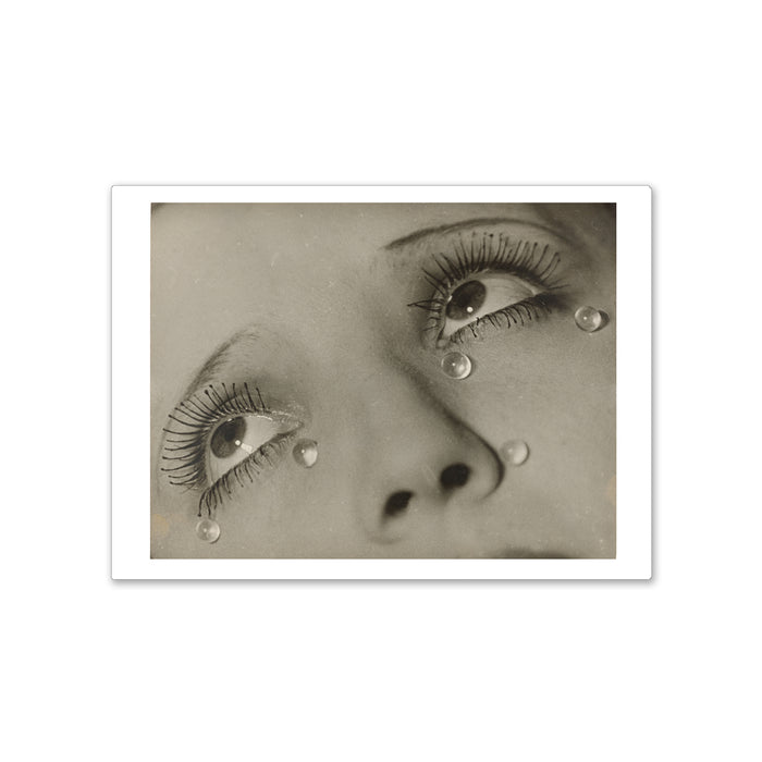 A magnet featuring a reproduction of Man Ray's photograph 'Larmes (Tears)', depicting a close-up of a woman's face with mascara-encrusted lashes and glass beads representing tears.