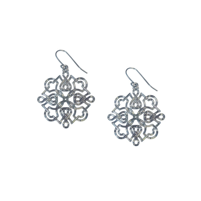 A pair of silver-colored, intricate pattern earrings designed to resemble calligraphy.