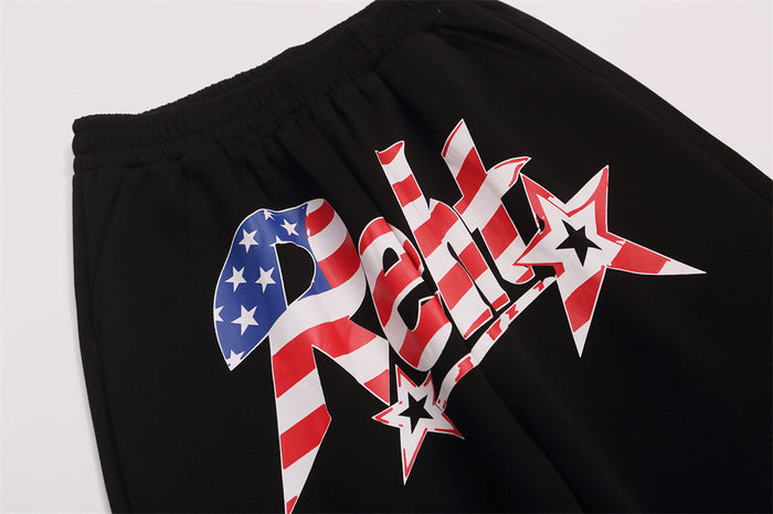 Close-up of black sweatpants waistband and bold red, white, and blue star front graphic
