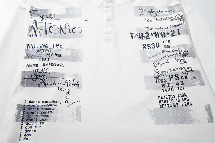 Close-up of the white shirt front showing layered black text, handwritten graphics, and gray rectangular blocks