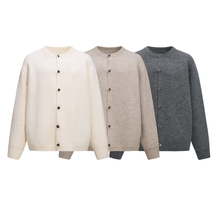 Three crewneck knit cardigans in ivory, beige, and charcoal with floral buttons shown from the front