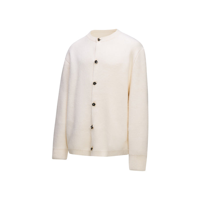 Ivory crewneck knit cardigan shown from the front with long sleeves, ribbed trim, and floral buttons