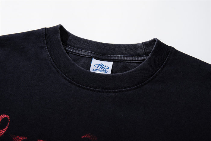Close-up of the black shirt’s ribbed crew neckline and sewn-in neck label