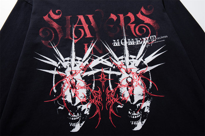 Close-up of the black shirt front showing red lettering, white spikes, and twin skull graphics