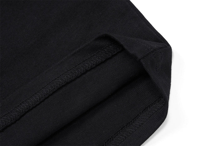 Close-up of black shirt fabric and double-stitched hem seam at the edge