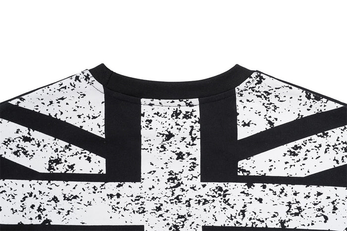 Close-up of a distressed white-and-black Union Jack graphic across the upper back of a black shirt