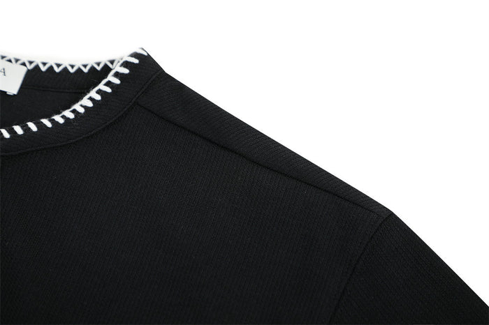 Black men’s Henley V-neck T-shirt with white contrast stitching on the collar and shoulder seam detail