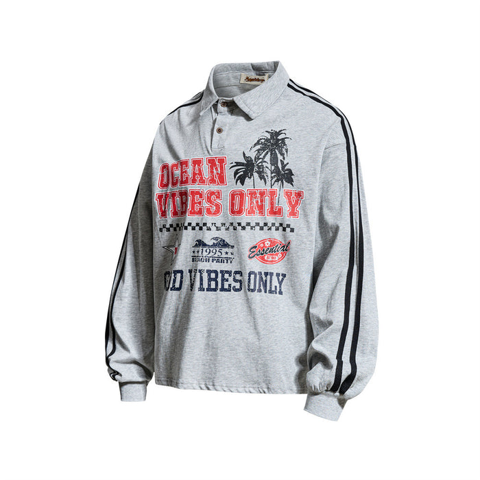 Angled front view of heather gray long sleeve rugby shirt with ocean graphic and striped sleeves